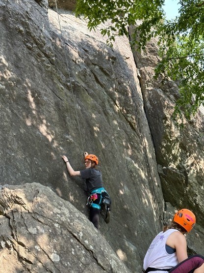 Julia climbing a rock wall.