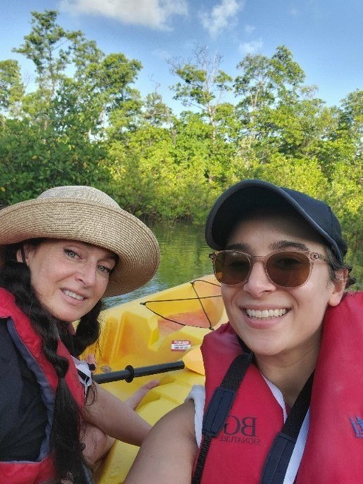 A couple of people in a boat smiling.